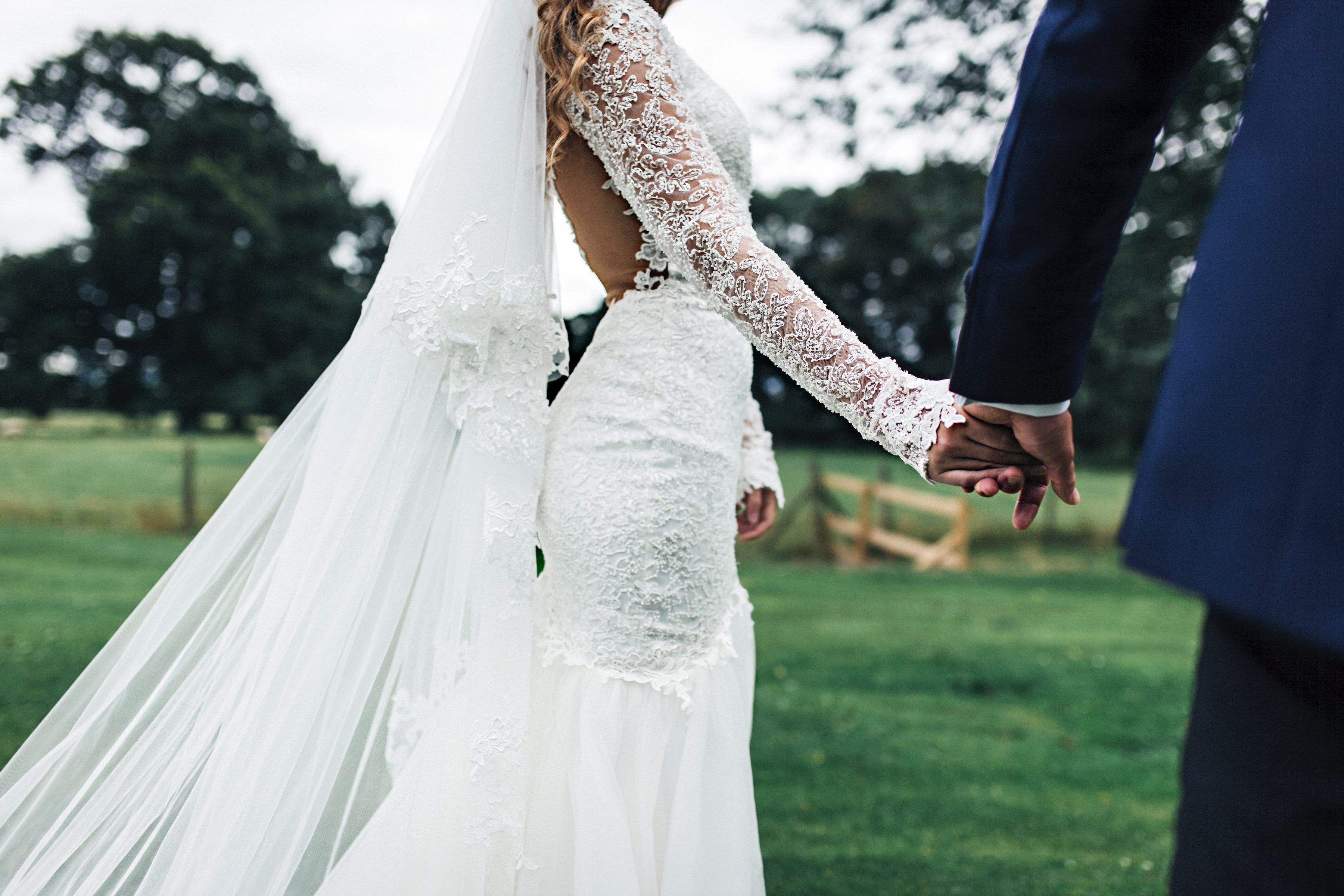 A wedding couple walking and holding hands