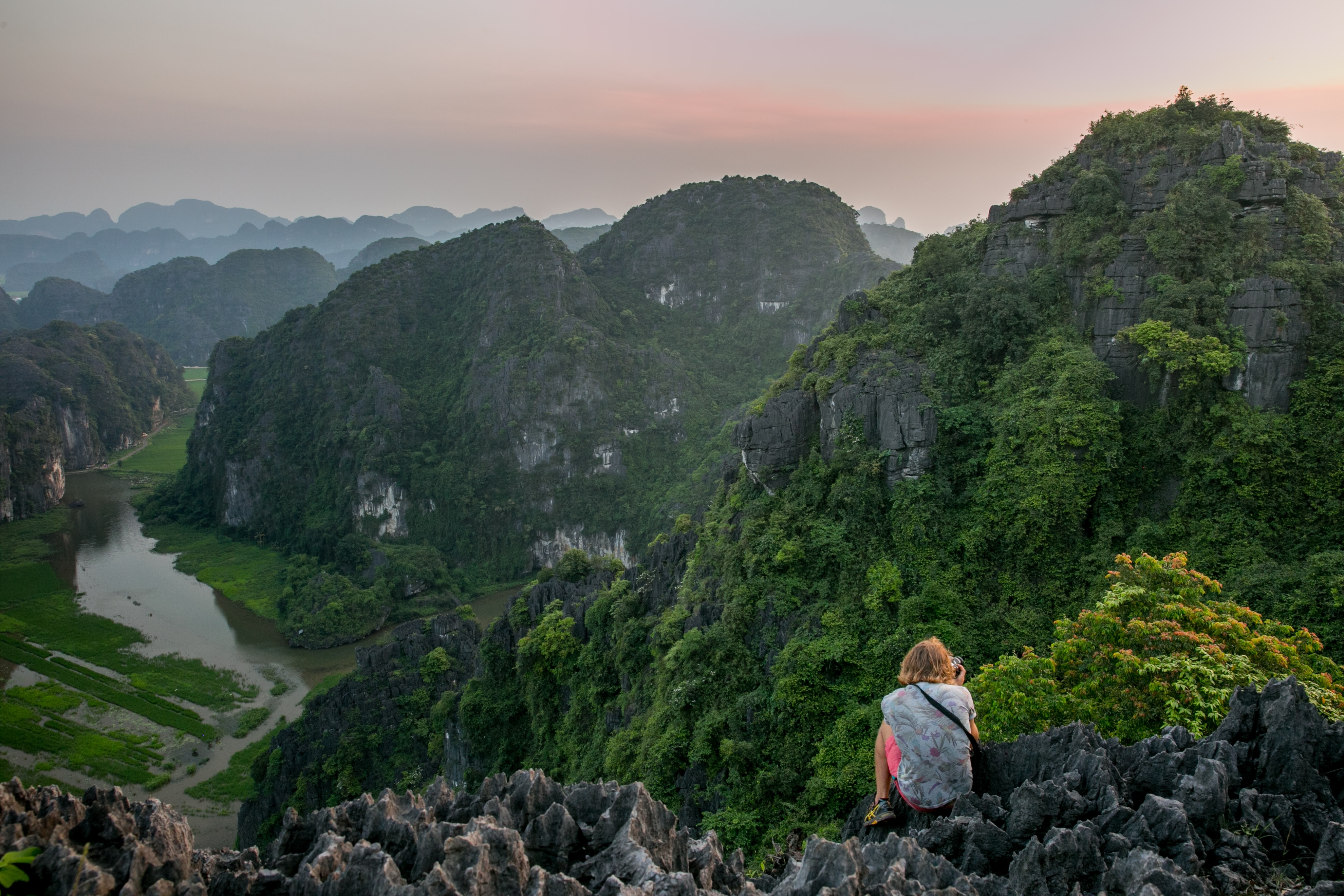 Landscape photograph of mountains, with woman in the forefront